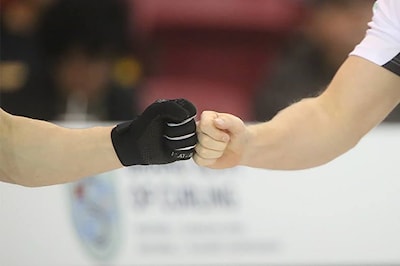 Detail of fist-bump between Ryan Fry (L) and Skip Brad Jacobs during the final draw against Team McEwen on November 23, 2014.