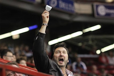 A member of the audience cheers on Team Jacobs late in the final draw against Team McEwen on November 23, 2014.