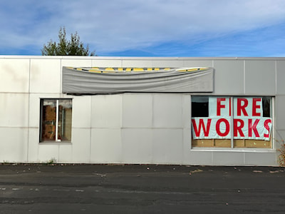 Blockbuster Video sign peeks through a covering on Trunk Road.