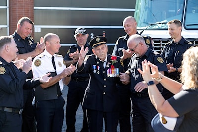 Jens 'Jake' Lamour waves a thanks after the firefighters at No. 1 Hall sing him happy birthday for his 100th on Sept. 7, 2022