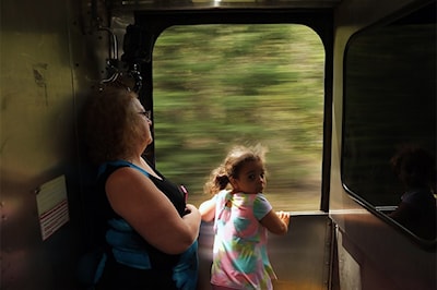 Monica White and her granddaughter Jocelynn watch from between ACR passenger cars on May 31, 2014. SooToday.com/Kenneth Armstrong