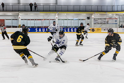 Jake Kovacs defends the puck against Michigan Tech in ACHA Hockey 