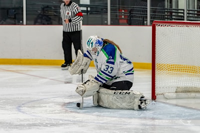 Cougars Goaltender Cassidy Dobson makes a save in ACHA hockey action 