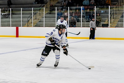 Ethan Esposito carries the puck in ACHA action